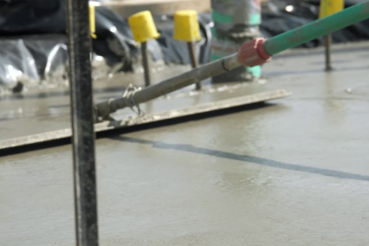 Fresh concrete being screeded level